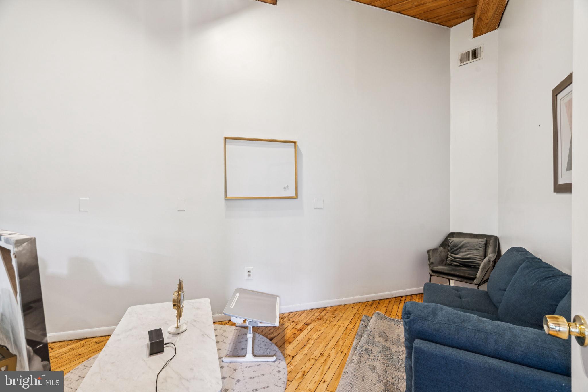 115 Cuthbert Street, Unit B Philadelphia, PA 19106 - Photo 13 of 30 a bedroom with a bed and couch