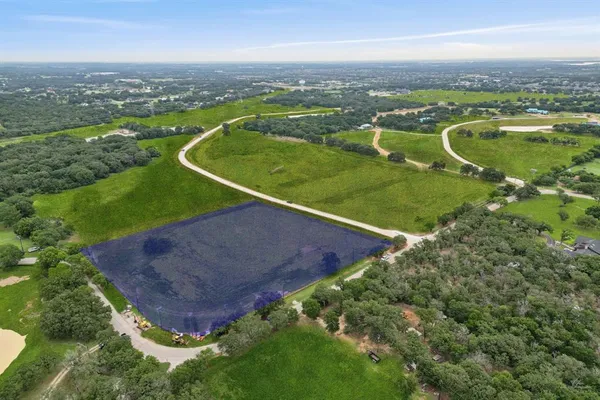 an aerial view of a golf course with parking space