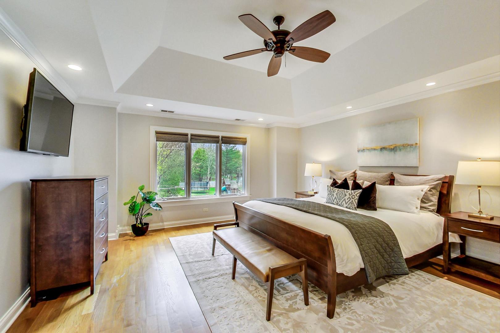 2027 Maple Avenue Northbrook, IL 60062 - Photo 11 of 27 a bedroom with a bed a flat screen tv and a couch