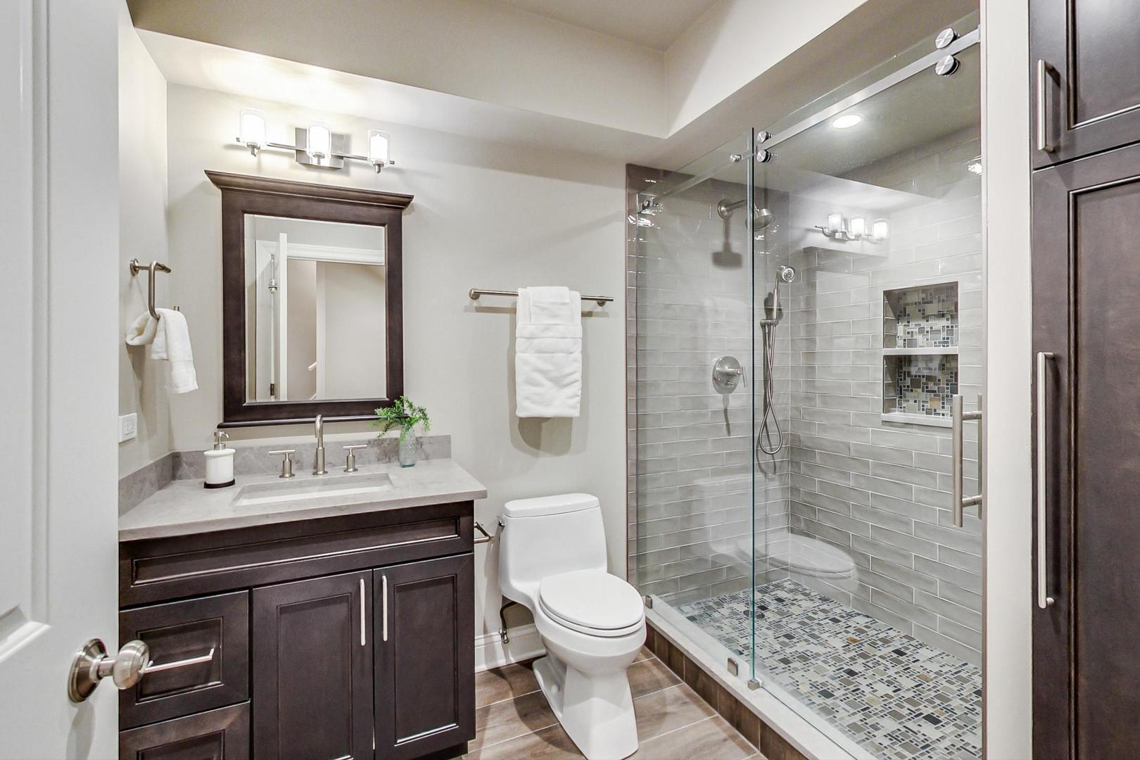2027 Maple Avenue Northbrook, IL 60062 - Photo 12 of 27 a bathroom with a sink a toilet and shower