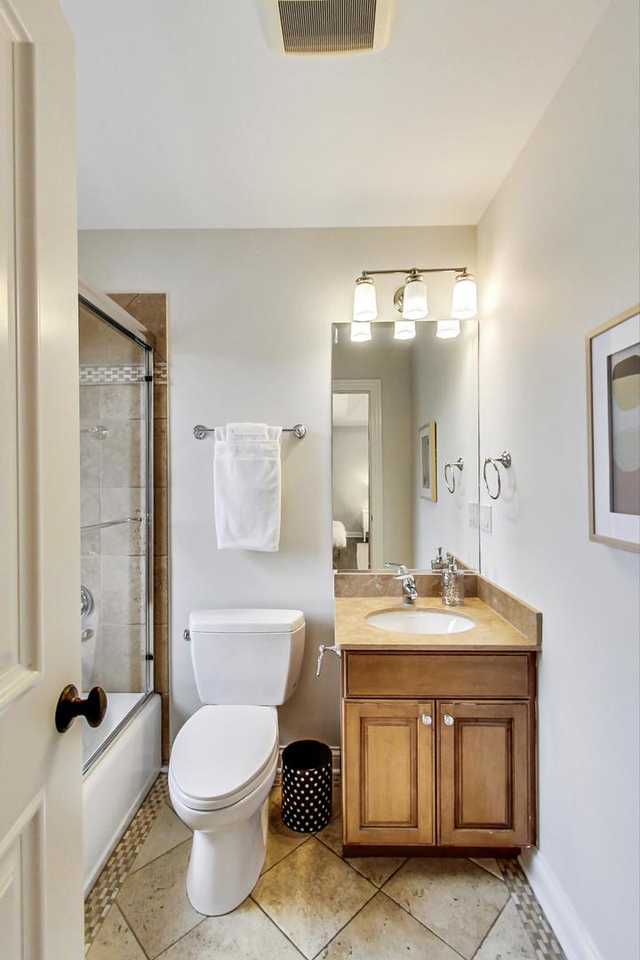2027 Maple Avenue Northbrook, IL 60062 - Photo 19 of 27 a bathroom with a toilet a sink a mirror and vanity