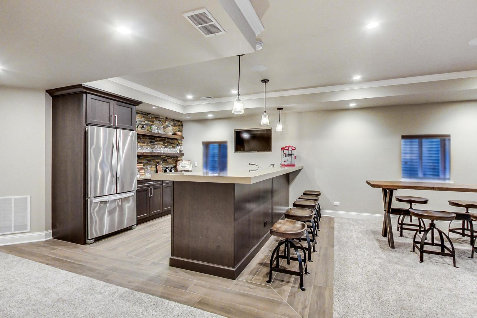 2027 Maple Avenue Northbrook, IL 60062 - Photo 21 of 27 a kitchen with stainless steel appliances kitchen island granite countertop a refrigerator and a stove top oven with white countertops