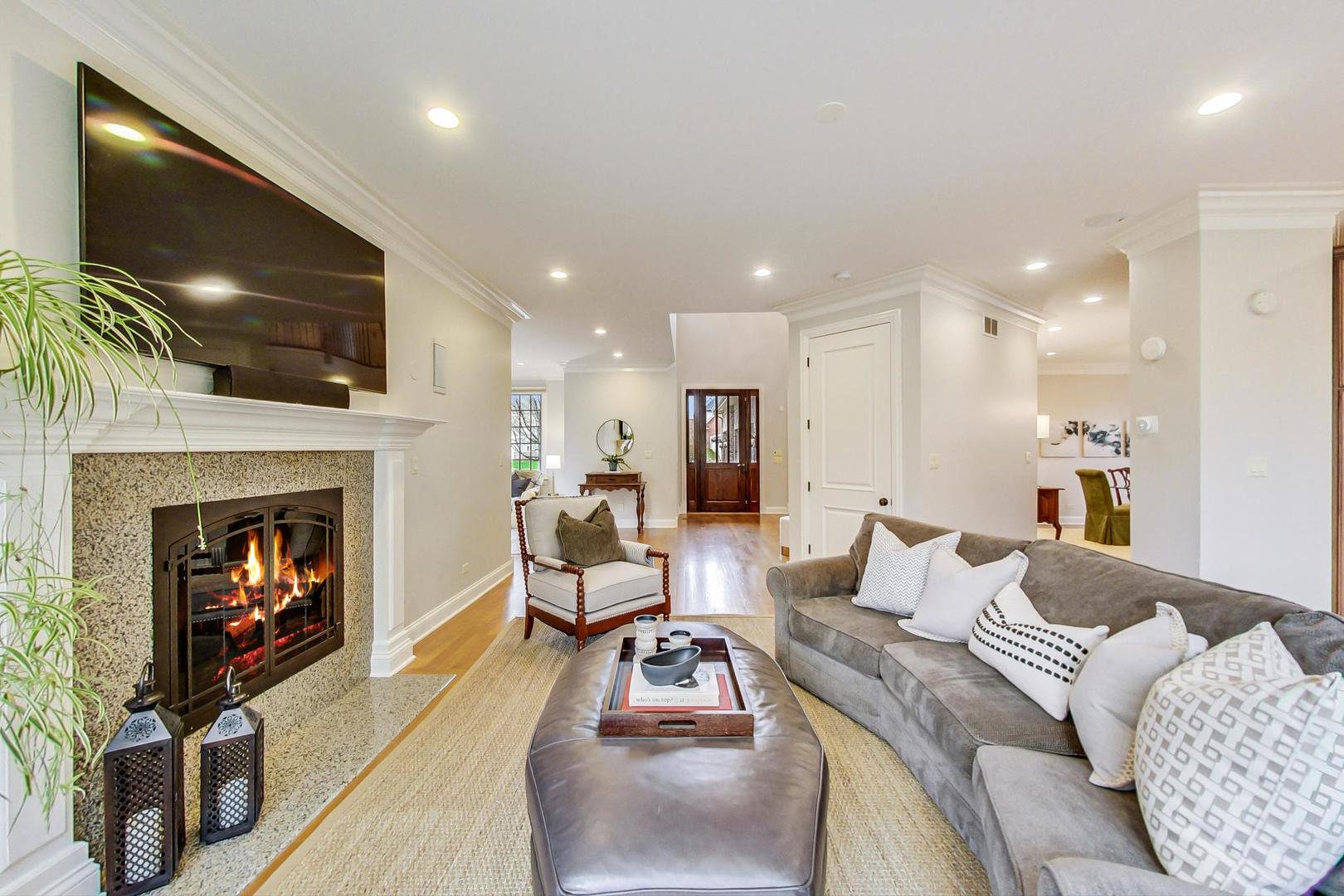 2027 Maple Avenue Northbrook, IL 60062 - Photo 8 of 27 a living room with furniture and a fireplace