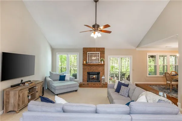 a living room with furniture a fireplace and a flat screen tv