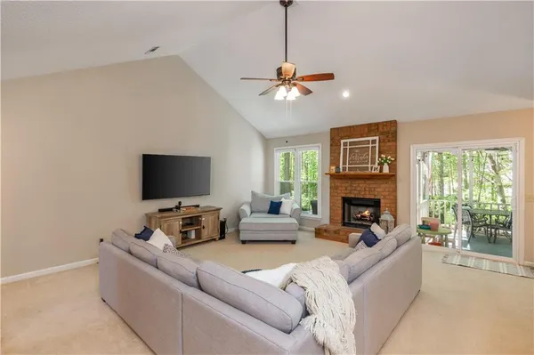 a living room with furniture a fireplace and a flat screen tv