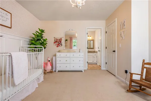 a bedroom with furniture and a baby crib