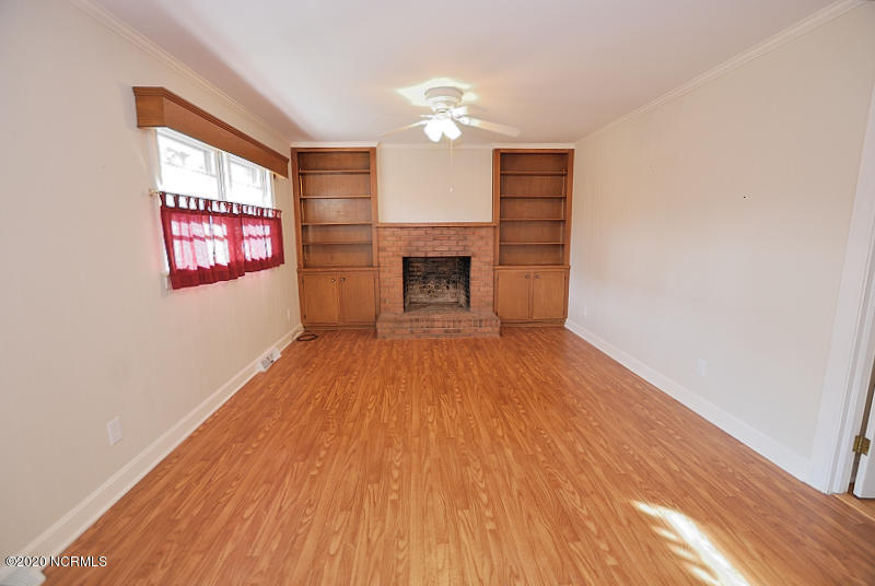3013 Amherst Road Rocky Mount, NC 27804 - Photo 5 of 14 Den with fireplace and built-in bookshelves.