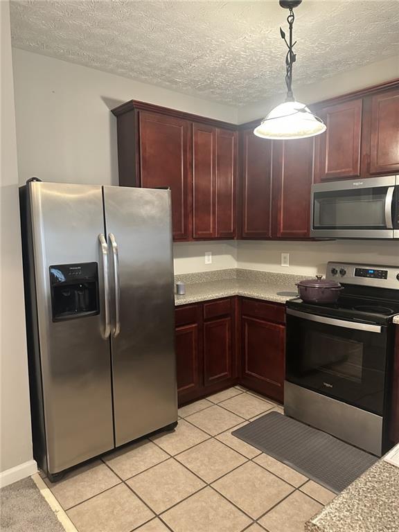 4360 Stone Gate Way, Unit 92 Atlanta, GA 30344 - Photo 15 of 18 a kitchen with granite countertop a refrigerator and a stove top oven
