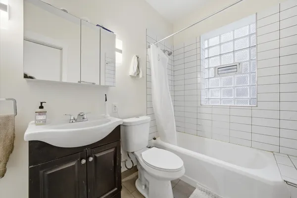 a bathroom with a sink toilet a mirror and shower