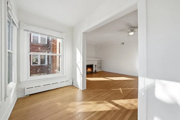 a view of empty room with wooden floor