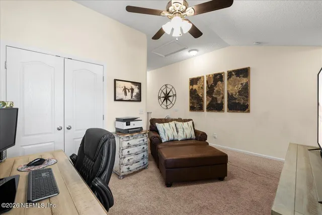 a living room with furniture and a ceiling fan