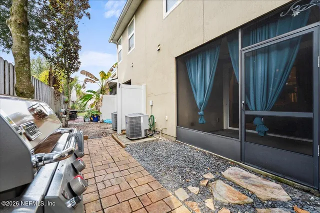 a view of a patio with table and chairs and potted plants