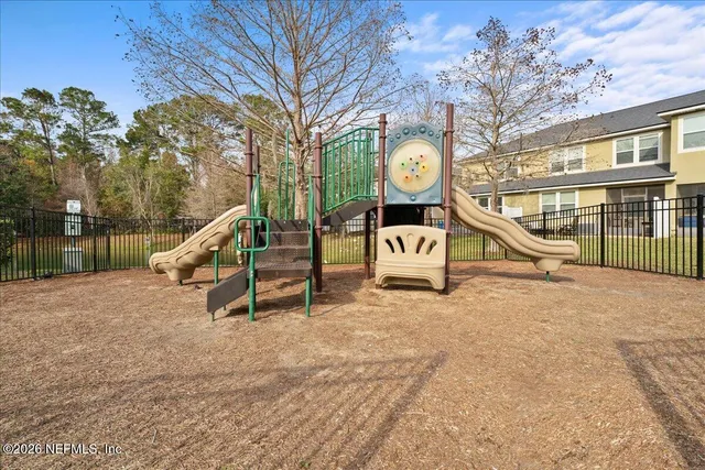 a view of a park with swings and a bench