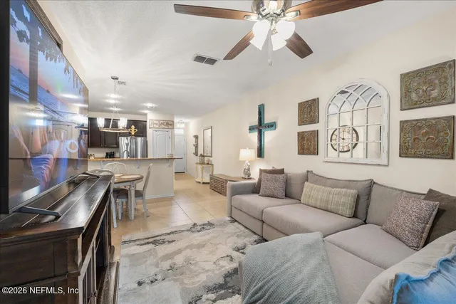 a living room with furniture and a chandelier