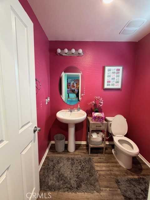 29451 Beeler Road Winchester, CA 92596 - Photo 7 of 19 a bathroom with a toilet a sink and mirror