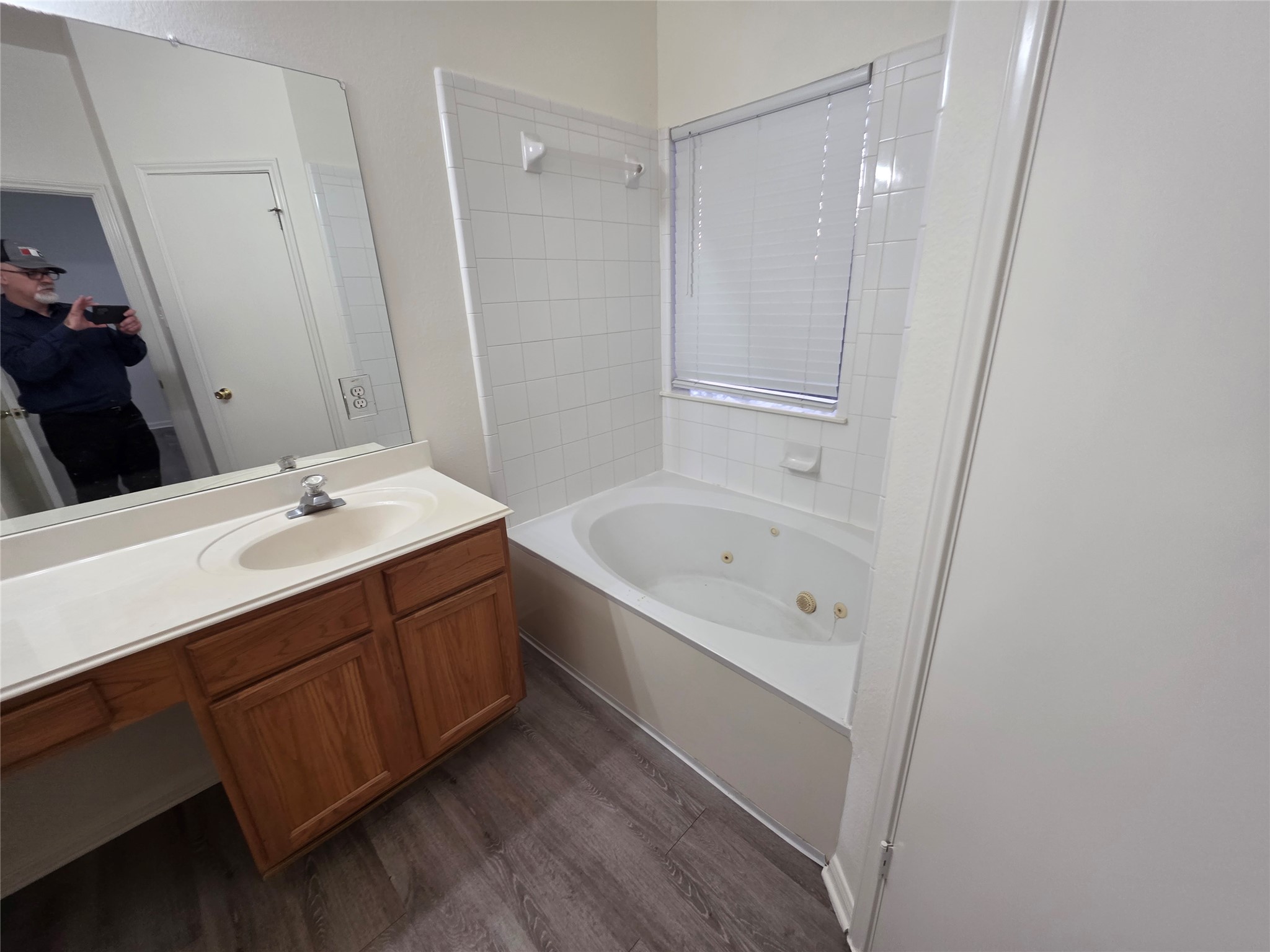 4417 Lendall Lane Austin, TX 78744 - Photo 6 of 23 a bathroom with a bathtub sink vanity and mirror
