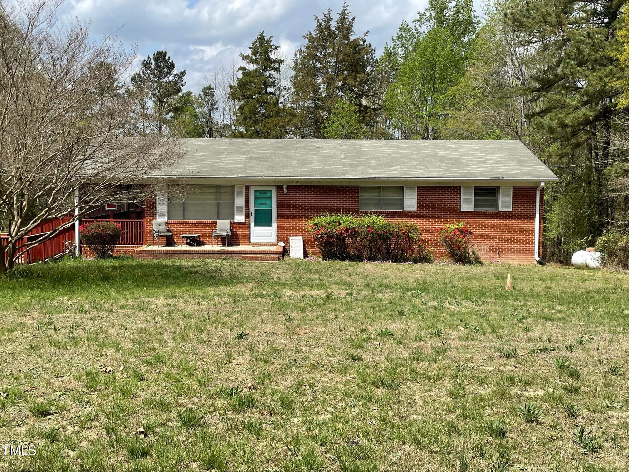 3311 Redwood Road Durham, NC 27704 - Photo 2 of 32 a front view of a house with a yard table and chairs