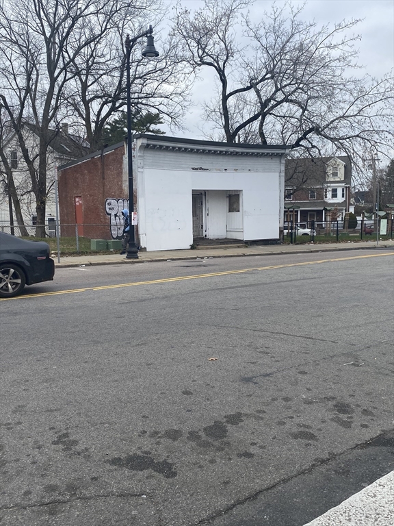a front view of a building with trees