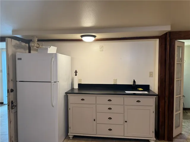 a kitchen with a refrigerator and cabinets
