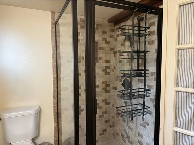 a bathroom with a glass door shower