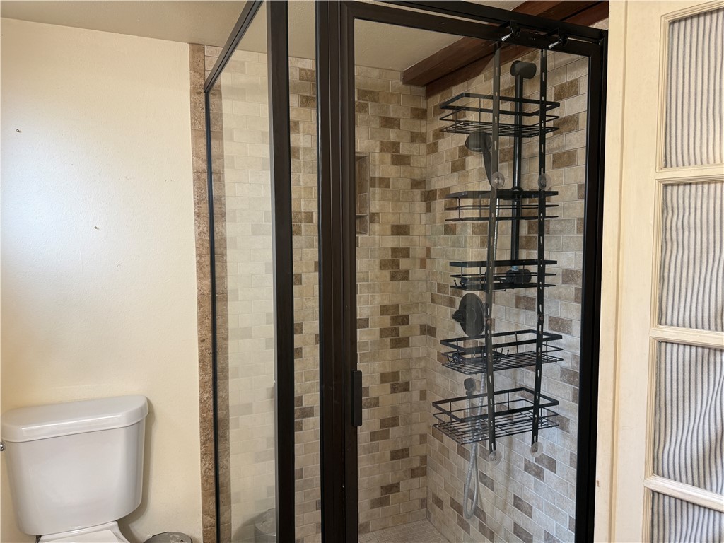 601 East 30th Street, Unit B Bryan, TX 77803 - Photo 8 of 15 a bathroom with a glass door shower