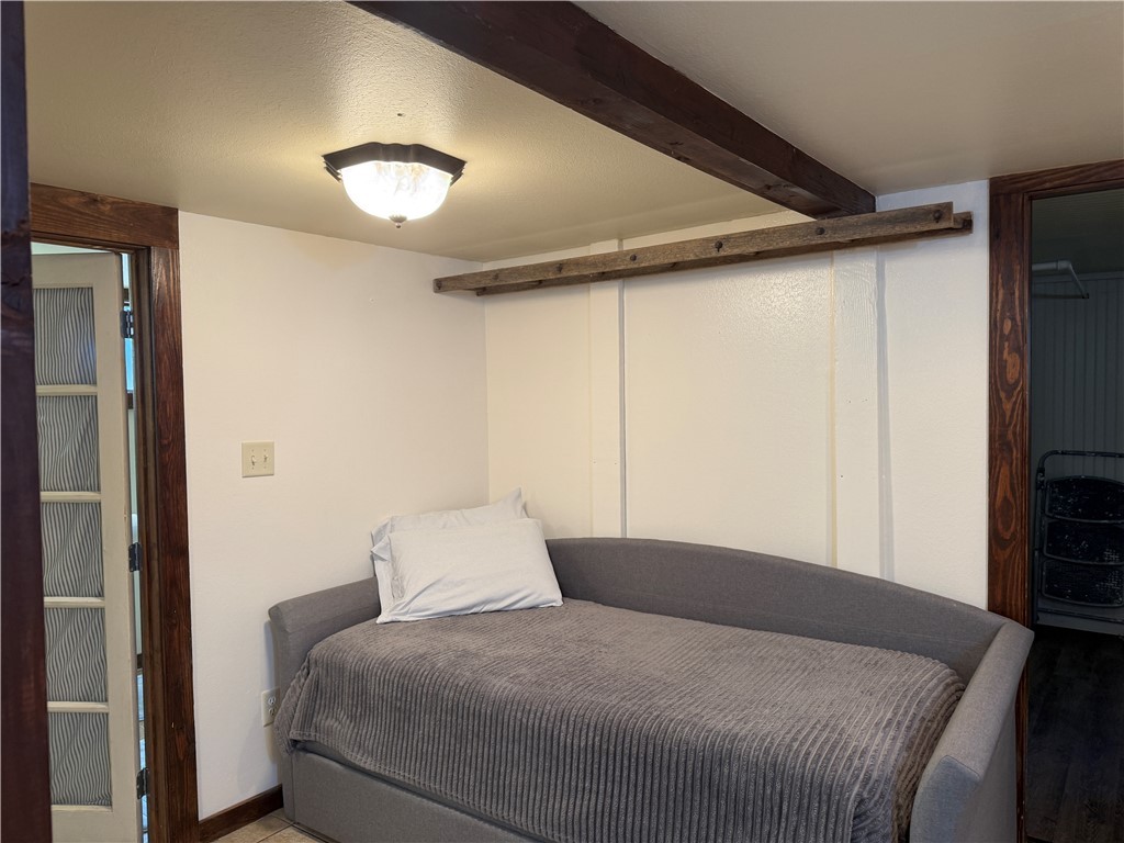 601 East 30th Street, Unit B Bryan, TX 77803 - Photo 10 of 15 a bedroom with a bed and a flat tv screen on dresser