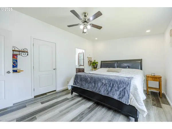 a bedroom with a bed and a ceiling fan