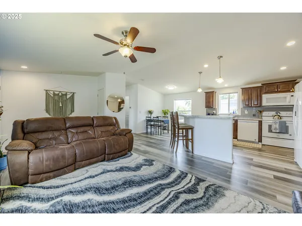 a living room with furniture and kitchen view