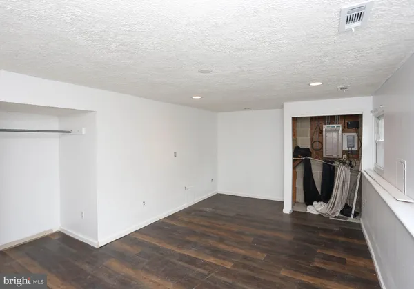 a view of a room with wooden floor and stairs