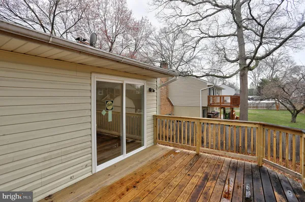 a view of a house with a wooden deck