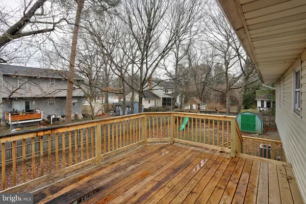 a view of a wooden deck with a yard