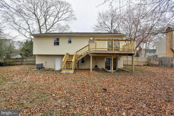 a view of a house with cars parked in a yard