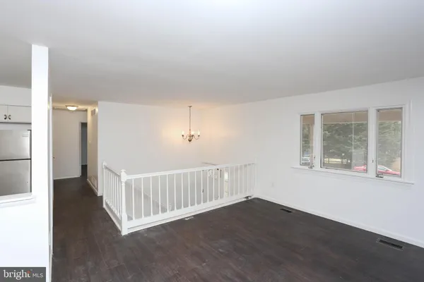 a view of a room with wooden floor and windows