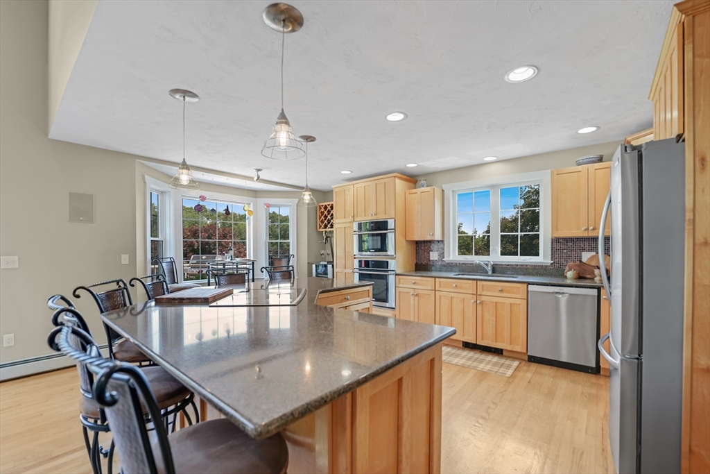 57 Perry Hill Road Acushnet, MA 02743 - Photo 13 of 40 a dining hall with stainless steel appliances granite countertop a dining table chairs and granite counter tops