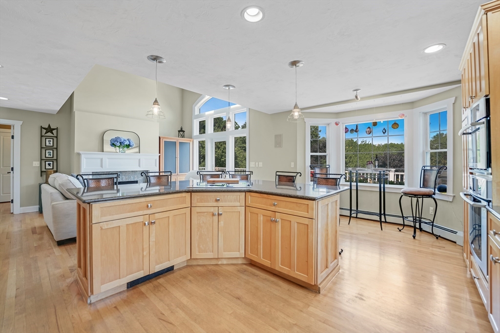 57 Perry Hill Road Acushnet, MA 02743 - Photo 16 of 40 a large white kitchen with granite countertop a stove and a sink