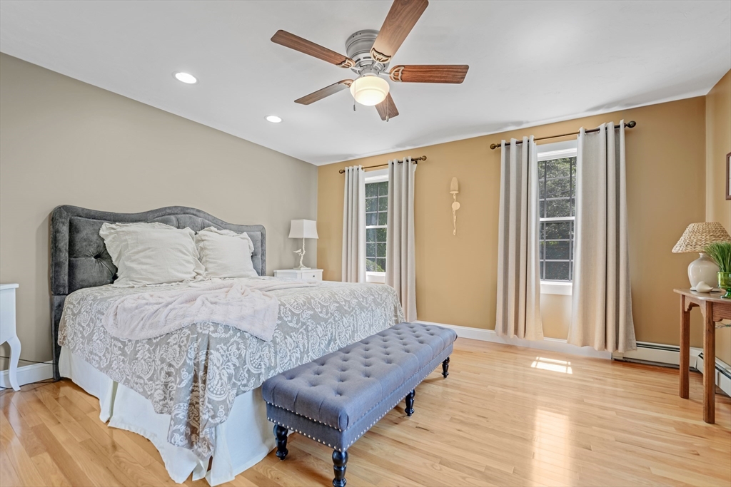 57 Perry Hill Road Acushnet, MA 02743 - Photo 22 of 40 a bedroom with a bed and a large window with wooden floor