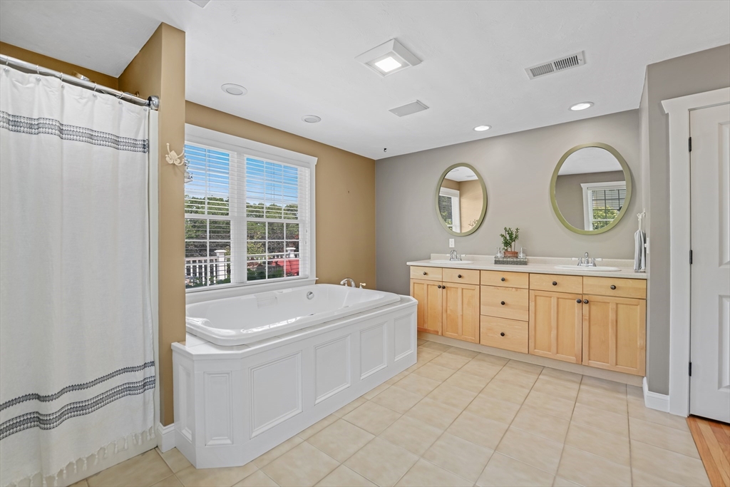 57 Perry Hill Road Acushnet, MA 02743 - Photo 25 of 40 a spacious bathroom with a tub sink and mirror