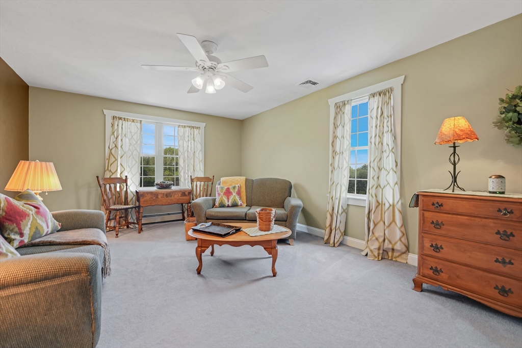 57 Perry Hill Road Acushnet, MA 02743 - Photo 27 of 40 a living room with furniture and a chandelier