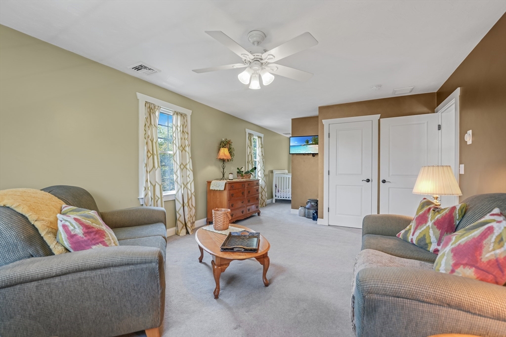 57 Perry Hill Road Acushnet, MA 02743 - Photo 28 of 40 a living room with furniture and a chandelier