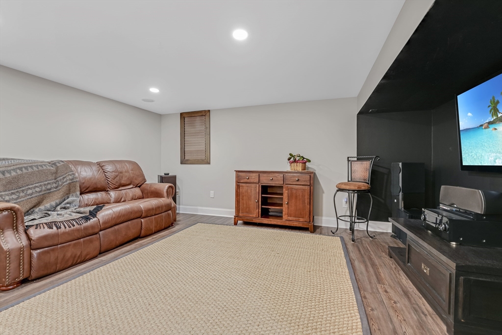 57 Perry Hill Road Acushnet, MA 02743 - Photo 35 of 40 a living room with furniture a fireplace and a flat screen tv