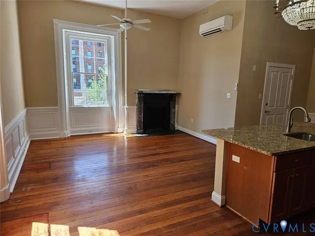 a view of kitchen with granite countertop window and wooden floor