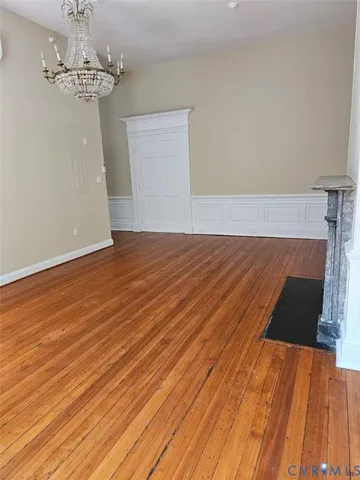 a view of a room with wooden floor and staircase