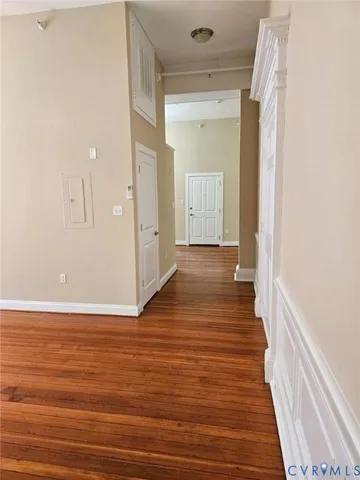 a view of a hallway with wooden floor