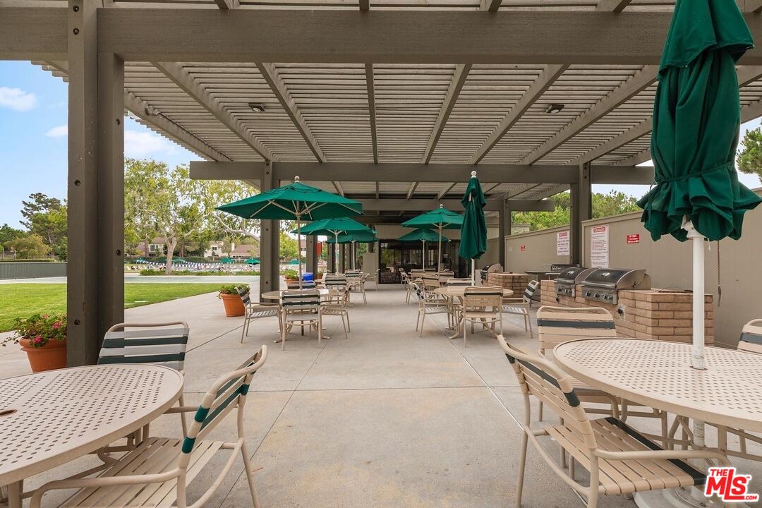 106 Sequoia Tree Lane Irvine, CA 92612 - Photo 28 of 36 a view of patio with a table under an umbrella