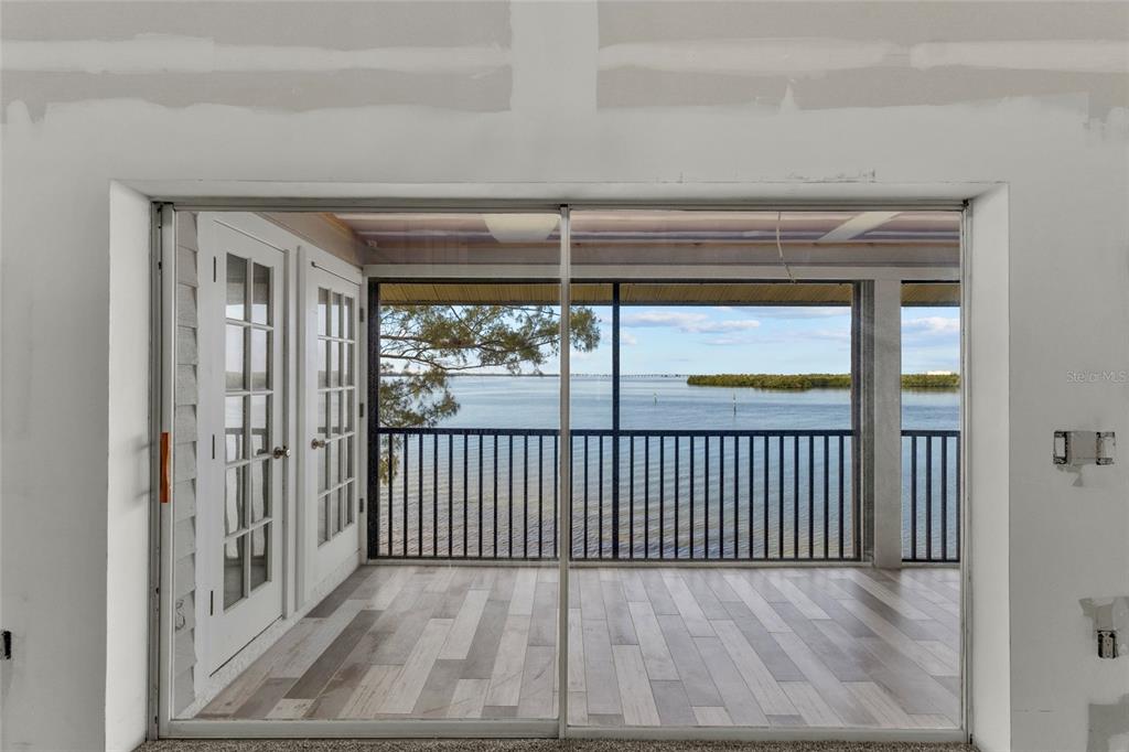 3840 Mariners Way, Unit 525 Cortez, FL 34215 - Photo 15 of 48 a view of a porch with wooden floor and a gate