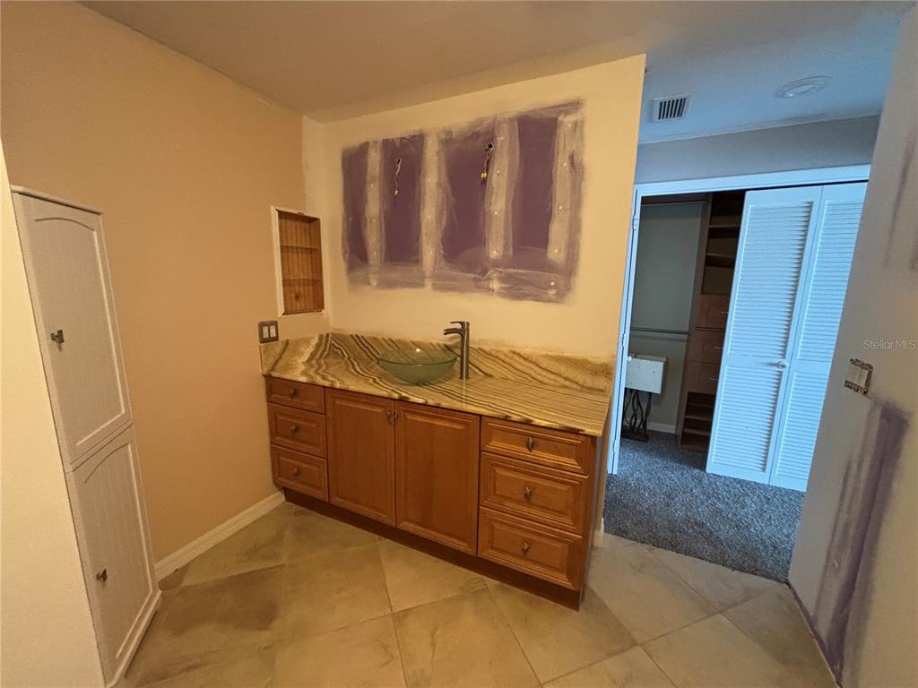 3840 Mariners Way, Unit 525 Cortez, FL 34215 - Photo 30 of 48 a room with sink and mirror