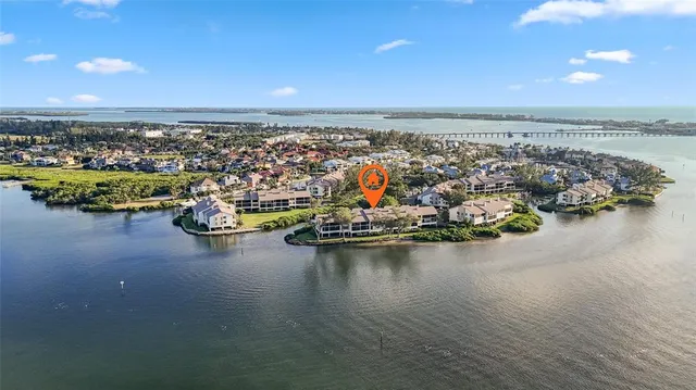 an aerial view of residential houses with outdoor space and lake view
