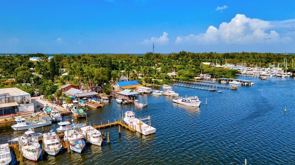 3840 Mariners Way, Unit 525 Cortez, FL 34215 - Photo 45 of 48 a view of a lake with lawn chairs