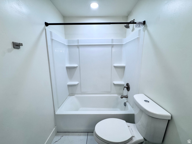 4729 Middleboro Road Herriman, UT 84096 - Photo 14 of 19 White bathtub with integrated shelving, brushed bronze fixtures, and a coordinating shower curtain rod