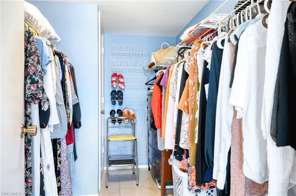 a view of walk in closet with clothes